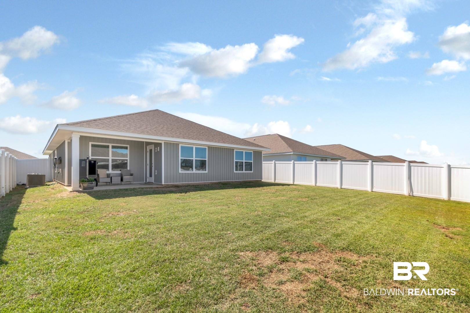 10921 Northern Dancer Court Daphne, AL 36526 - Photo 29 of 32 Back of property with a patio, a yard, and central air condition unit