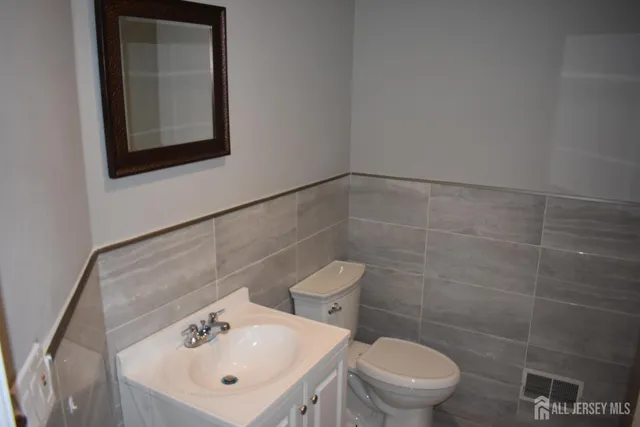 a view of a hallway with wooden floor and entryway