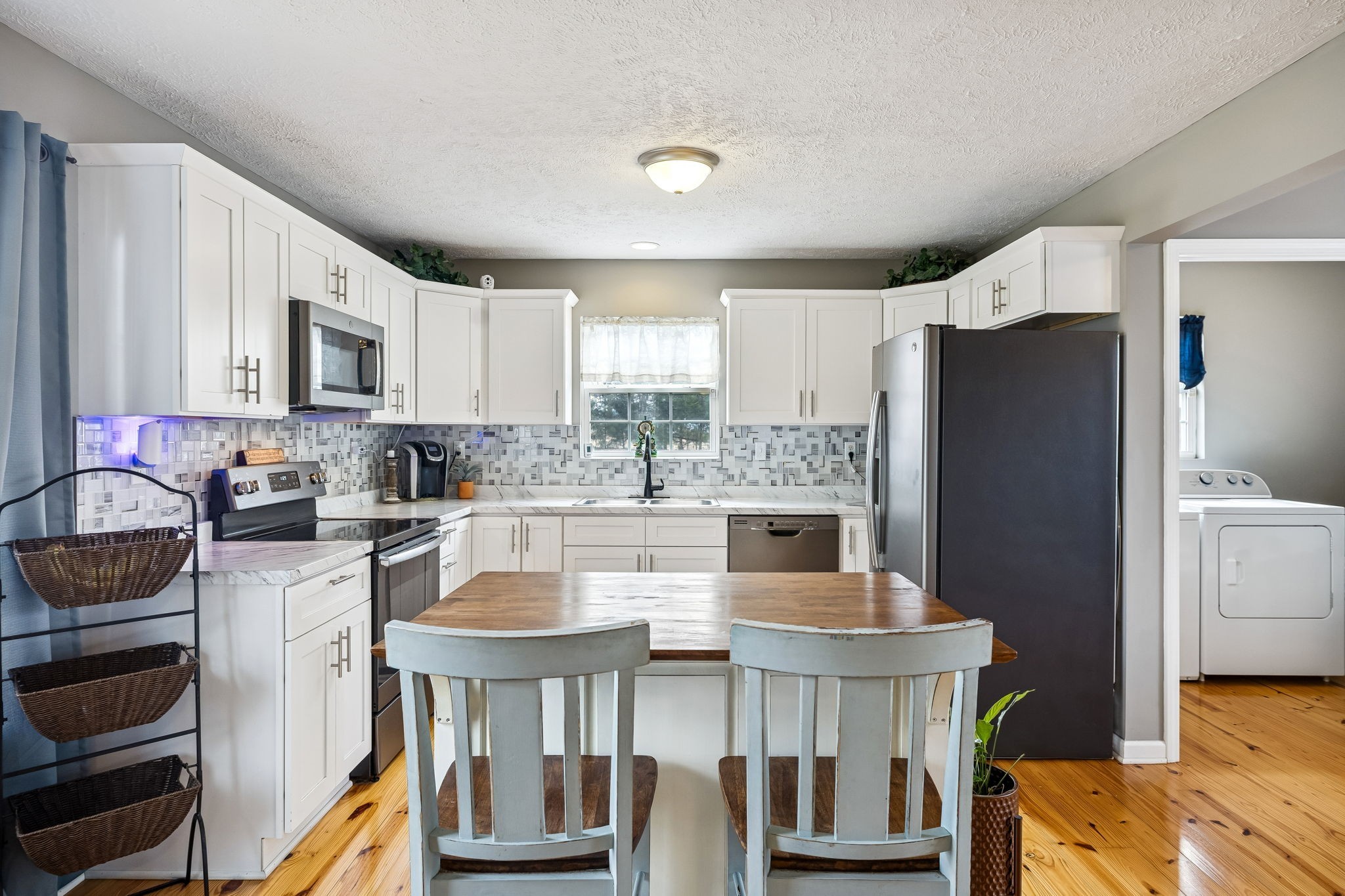 110 Ben Green Road Lebanon, TN 37090 - Photo 12 of 61 a kitchen with stainless steel appliances granite countertop a refrigerator a stove a sink dishwasher and white cabinets with wooden floor