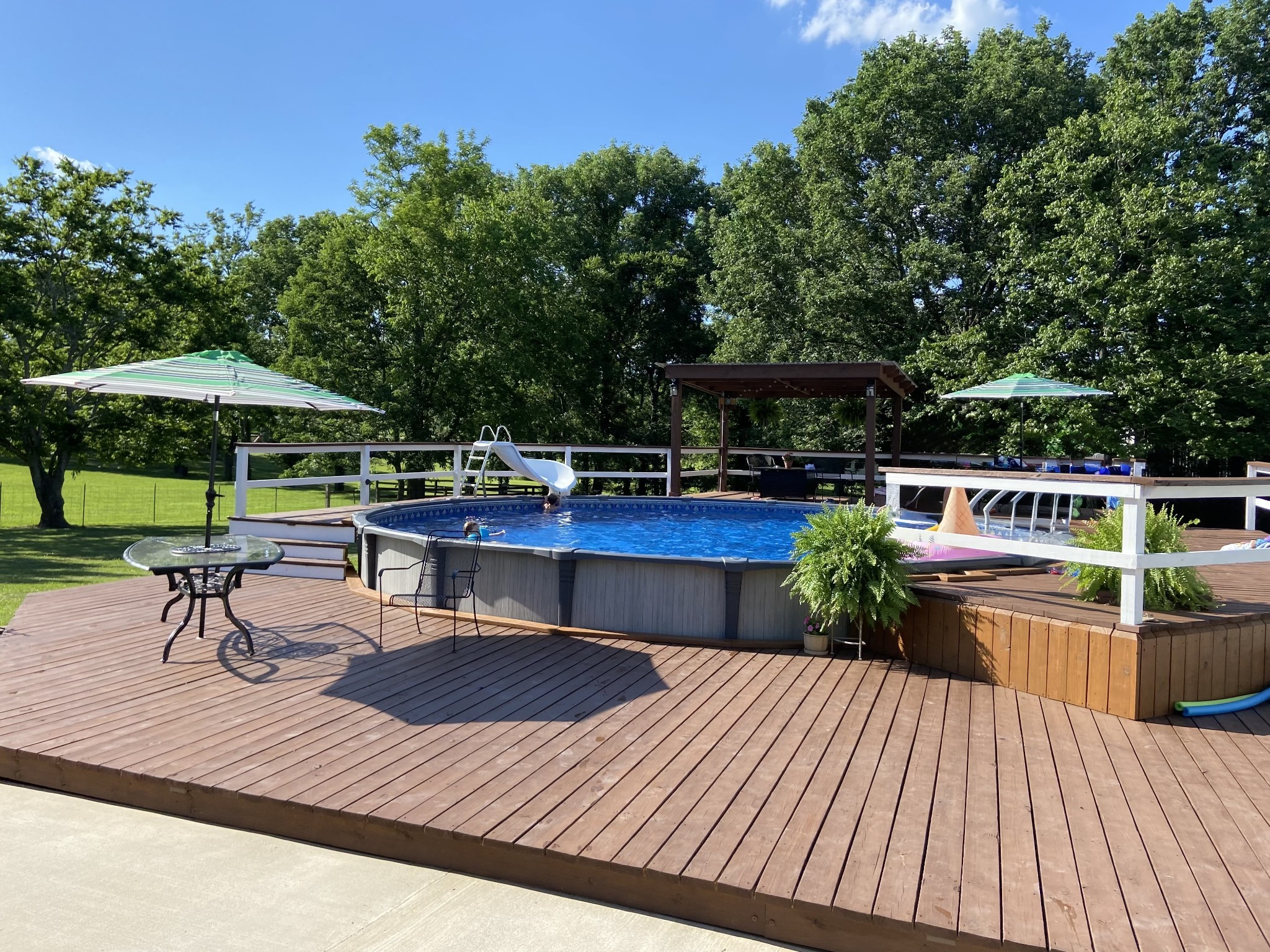 110 Ben Green Road Lebanon, TN 37090 - Photo 47 of 61 a view of a roof deck with table and chairs under an umbrella with wooden floor