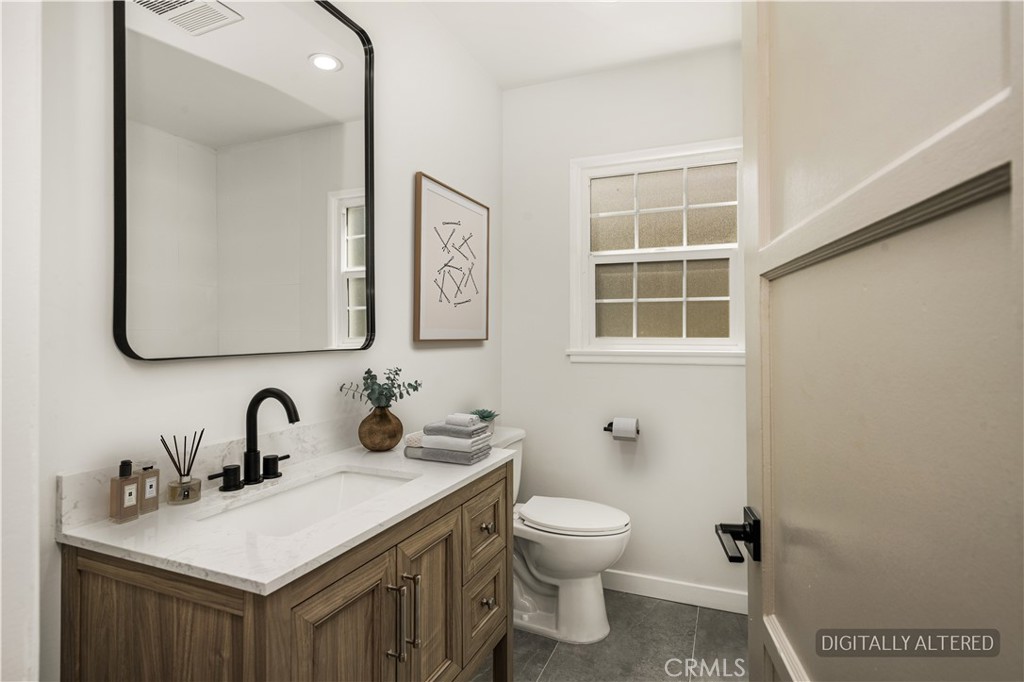 1013 West 138th Street Compton, CA 90222 - Photo 17 of 30 a bathroom with a toilet sink and mirror