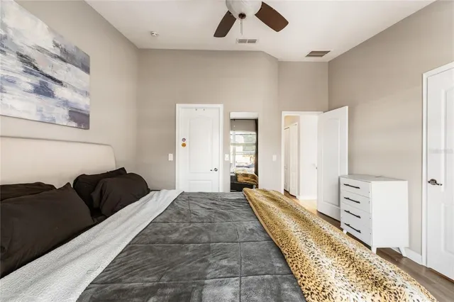 a bedroom with a bed and wooden floor