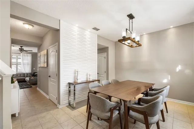 a dining room with a table and chairs