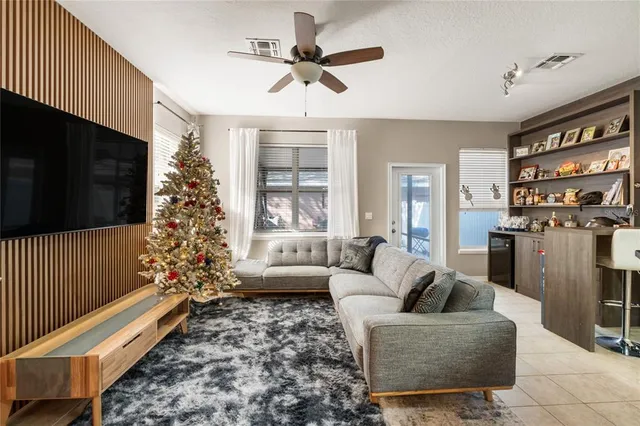 a living room with furniture a flat screen tv and a rug