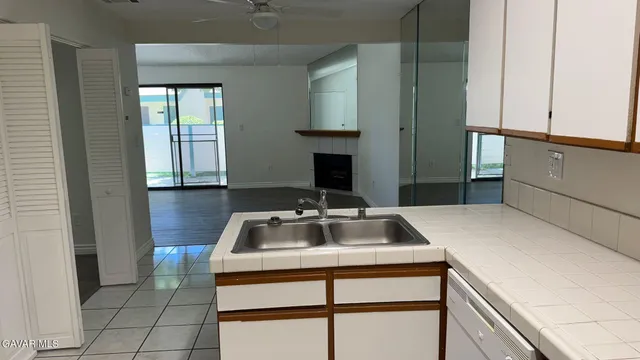 an empty room with wooden floor and mirror