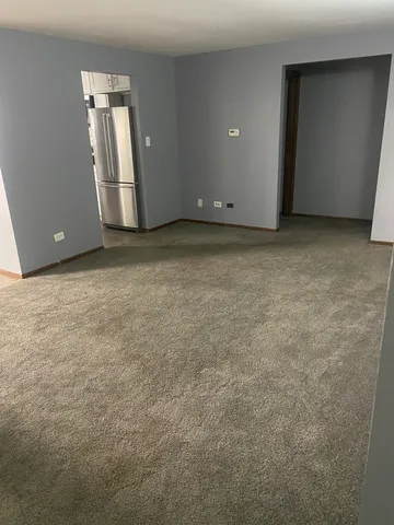 a kitchen with granite countertop a refrigerator sink and cabinets