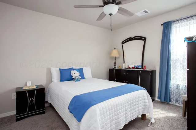 a bedroom with a bed and a mirror