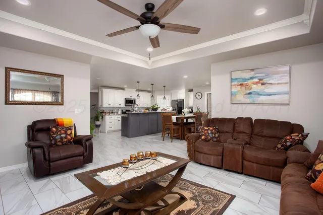 a living room with furniture and a dining table