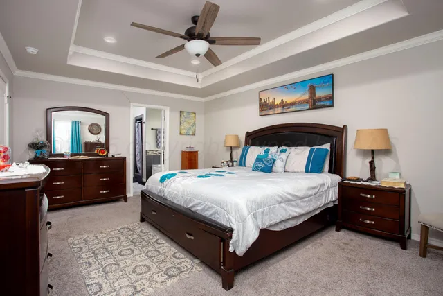 a bedroom with a bed and a mirror on dresser