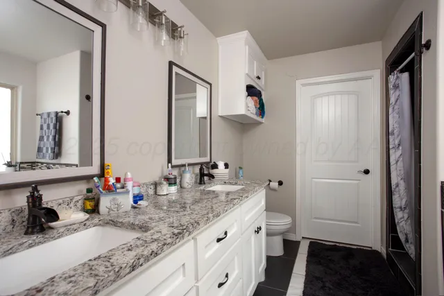 a bathroom with sink double vanity and mirror