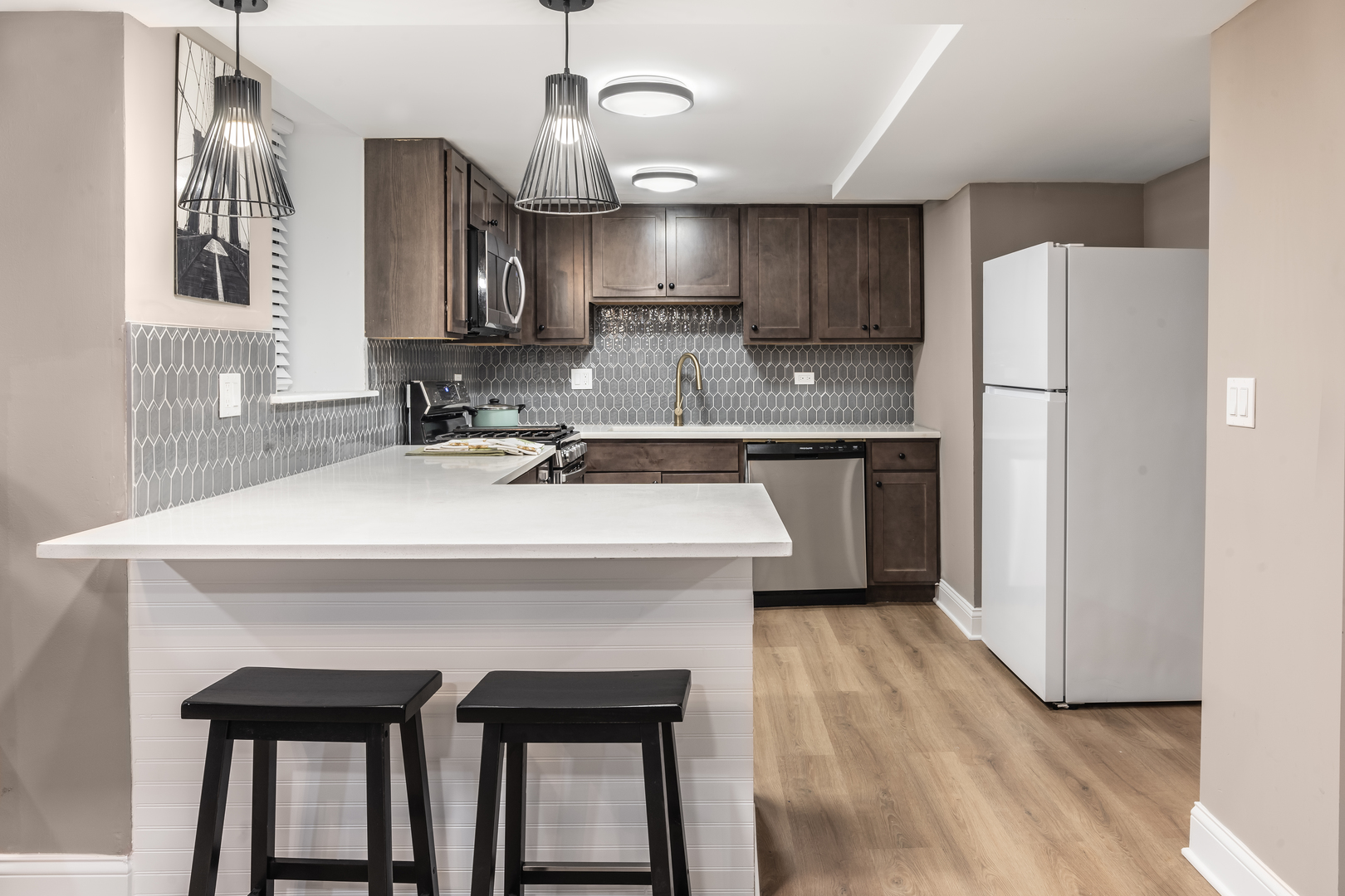 5011 South Drexel Boulevard Chicago, IL 60615 - Photo 5 of 8 a kitchen with kitchen island a sink stainless steel appliances and cabinets