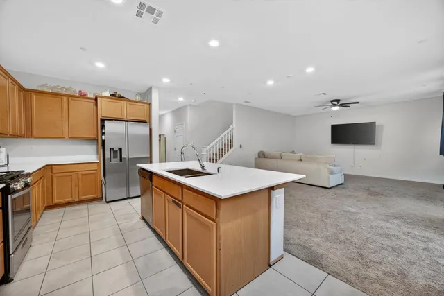 a kitchen with stainless steel appliances kitchen island granite countertop a sink and cabinets