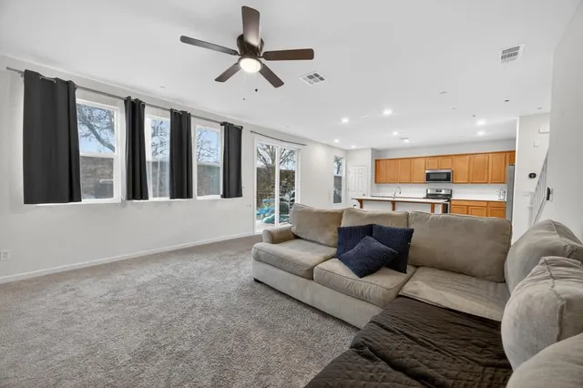 a living room with furniture and kitchen view