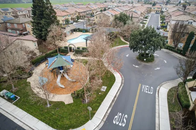 an aerial view of residential houses with outdoor space and river