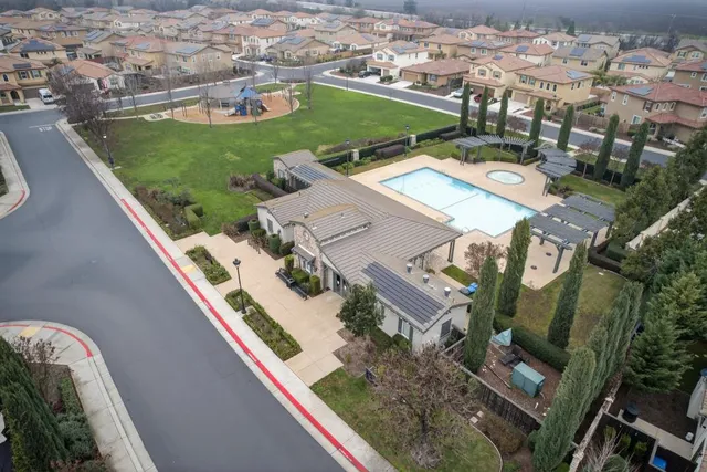 an aerial view of a house with a yard and lake view