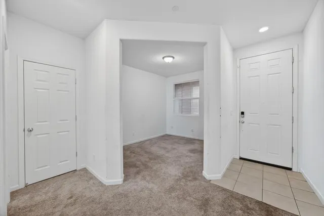 an empty room with closet and mirror