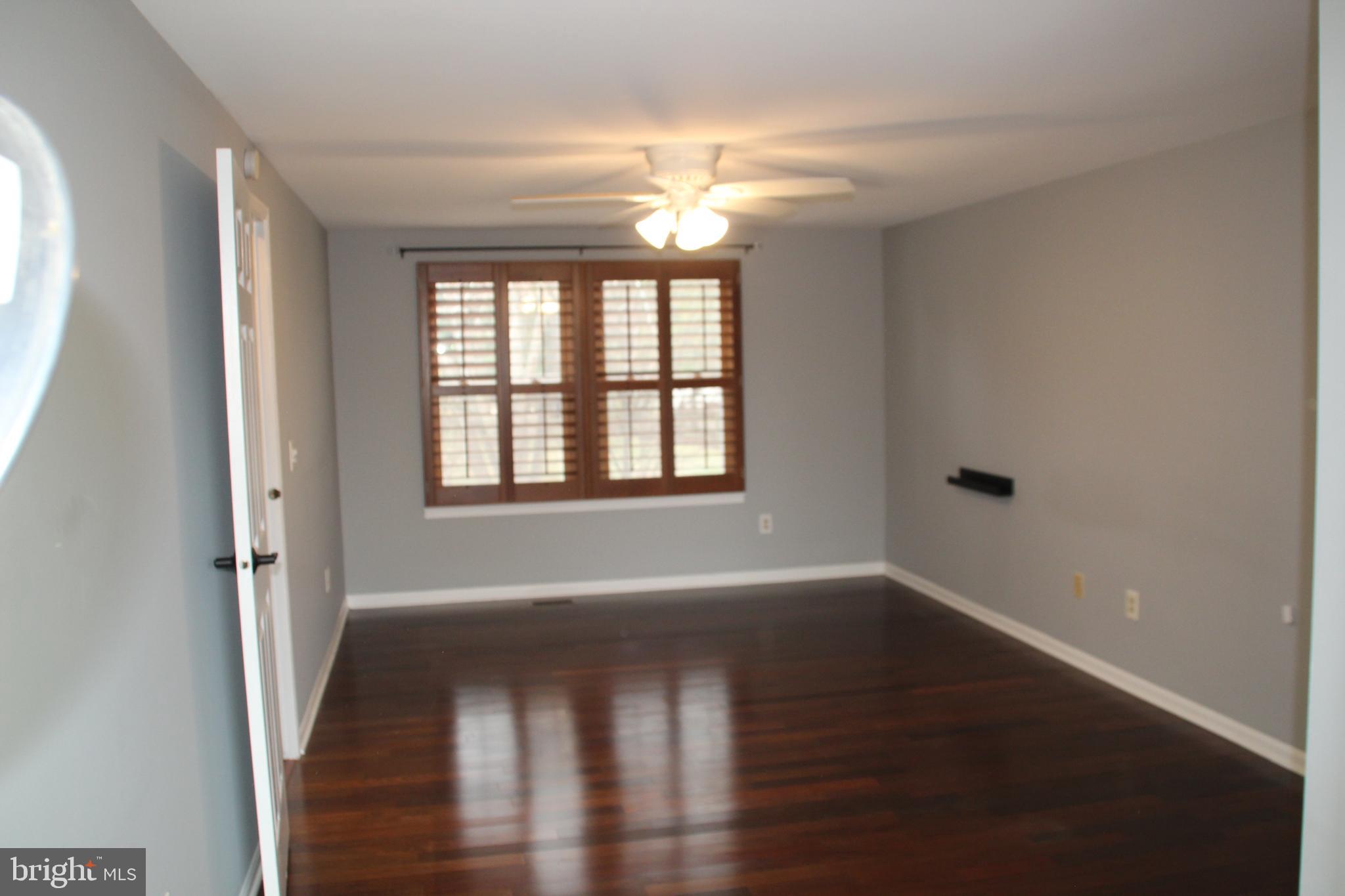 12507 Thunder Chase Drive Reston, VA 20191 - Photo 19 of 27 a view of an empty room with wooden floor and a window
