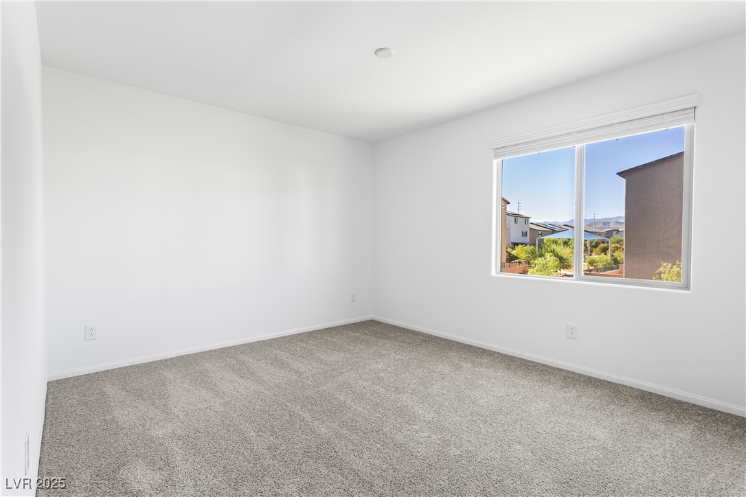 5646 Spring Trellis Street Las Vegas, NV 89113 - Photo 10 of 25 Empty room featuring baseboards and carpet floors