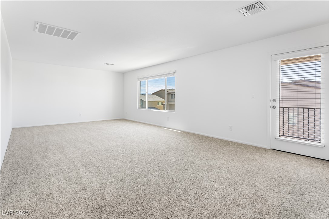 5646 Spring Trellis Street Las Vegas, NV 89113 - Photo 13 of 25 Empty room featuring light carpet and baseboards