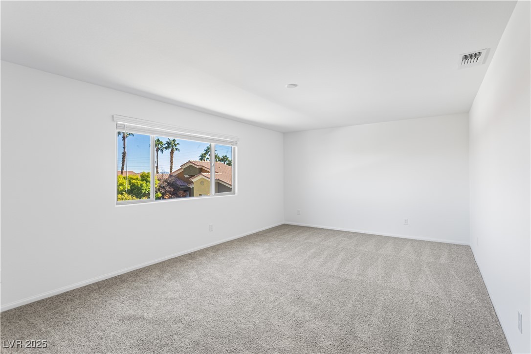 5646 Spring Trellis Street Las Vegas, NV 89113 - Photo 15 of 25 Empty room with light carpet and baseboards