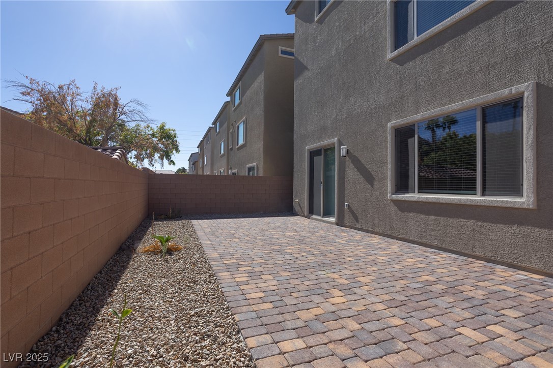 5646 Spring Trellis Street Las Vegas, NV 89113 - Photo 17 of 25 Fenced backyard featuring a patio area