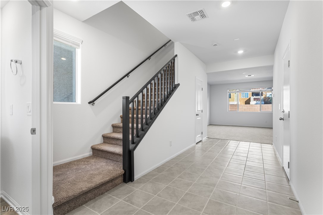 5646 Spring Trellis Street Las Vegas, NV 89113 - Photo 2 of 25 Staircase featuring tile patterned floors, carpet, and recessed lighting