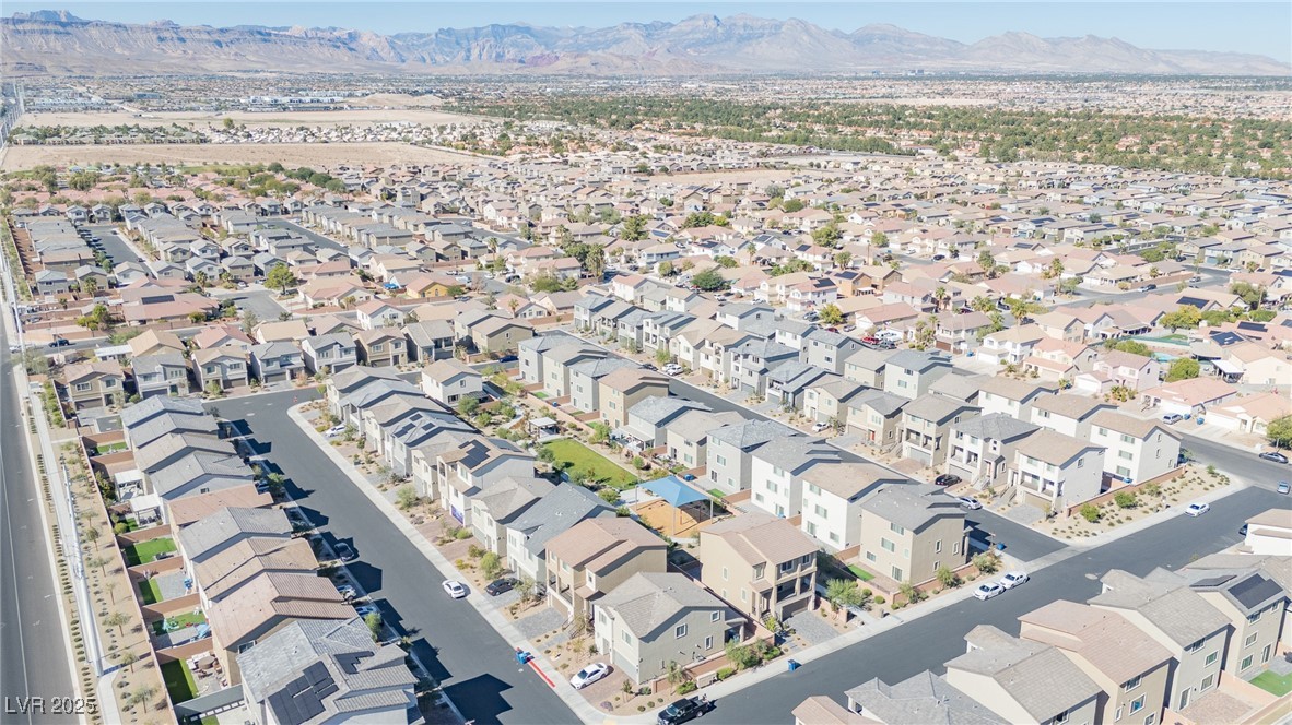 5646 Spring Trellis Street Las Vegas, NV 89113 - Photo 23 of 25 Aerial view of property's location featuring a mountainous background and nearby suburban area