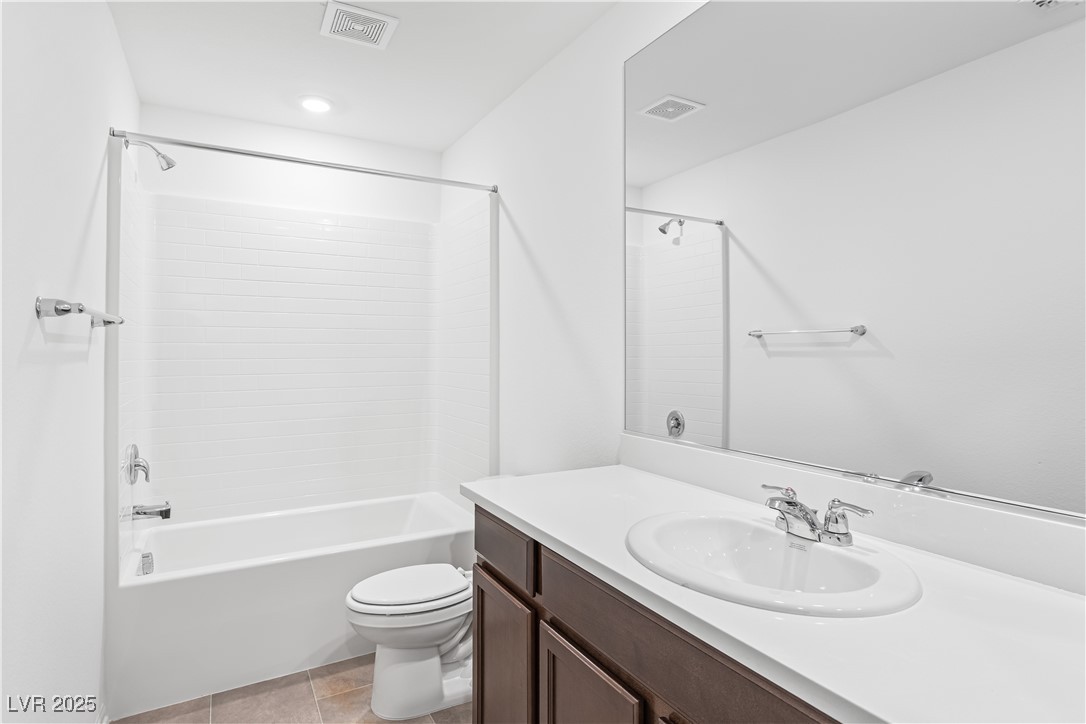 5646 Spring Trellis Street Las Vegas, NV 89113 - Photo 7 of 25 Full bathroom with vanity, shower / tub combination, and light tile patterned floors