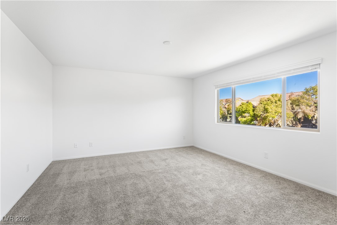 5646 Spring Trellis Street Las Vegas, NV 89113 - Photo 8 of 25 Carpeted empty room featuring baseboards