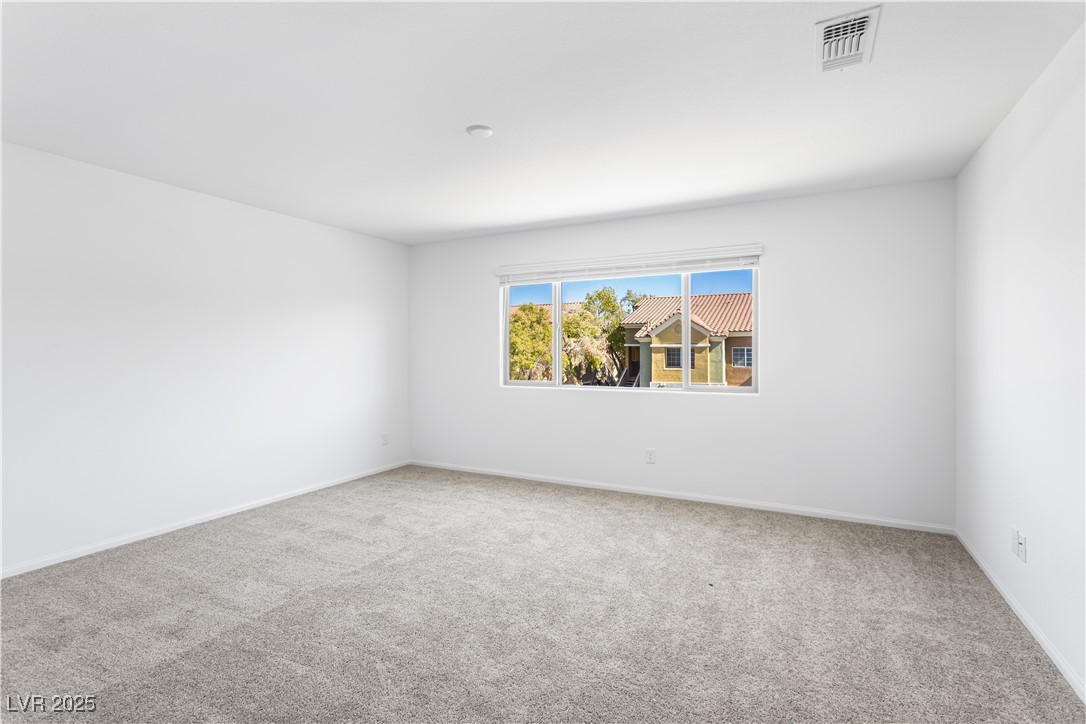 5646 Spring Trellis Street Las Vegas, NV 89113 - Photo 9 of 25 Unfurnished room with light carpet and baseboards