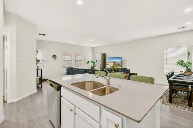 a kitchen with granite countertop white cabinets stainless steel appliances and sink