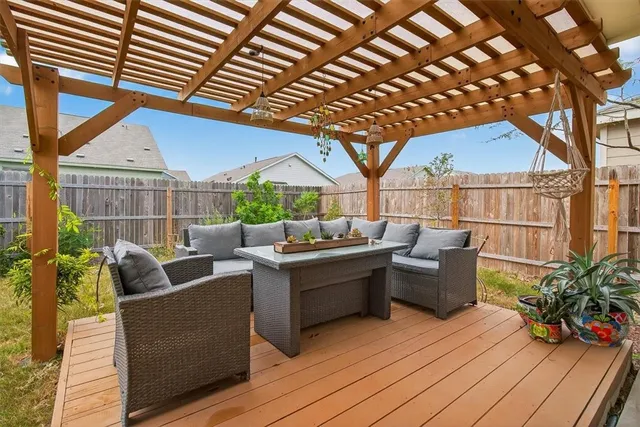 a view of a house with a yard and potted plants