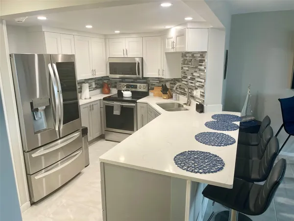 a kitchen with a dining table and chairs