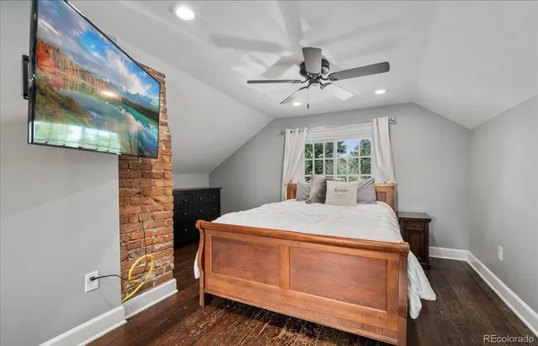a view of a room with a window and wooden floor