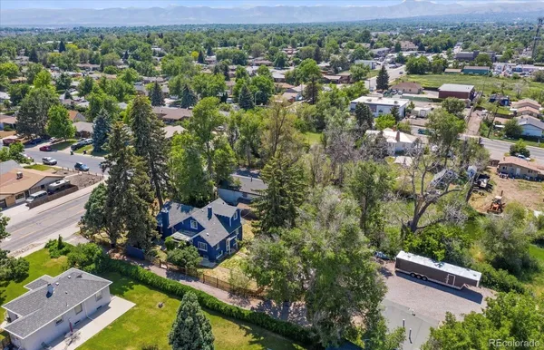 an aerial view of a house with a yard