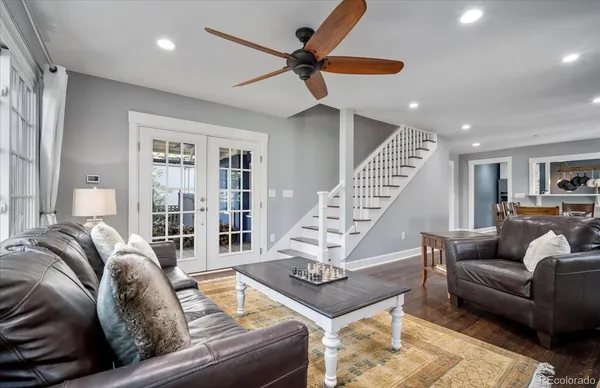 a living room with furniture ceiling fan and a rug