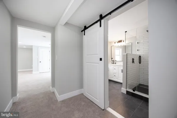 a bathroom with a shower and a glass door