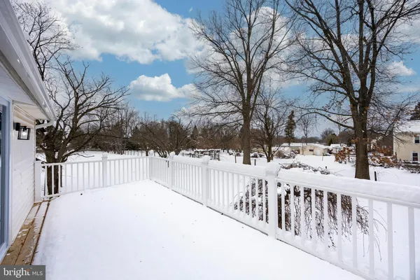 a view of a wooden fence covered with snow