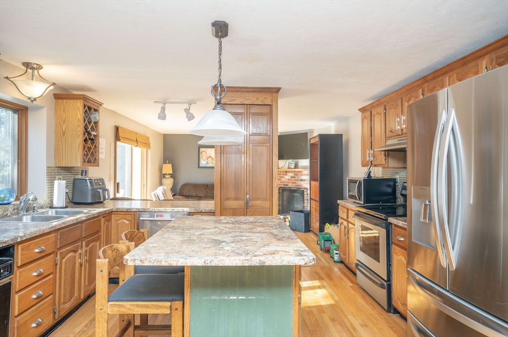22 Dinahs Way Wareham, MA 02571 - Photo 12 of 42 a large kitchen with kitchen island granite countertop a large counter top appliances and cabinets