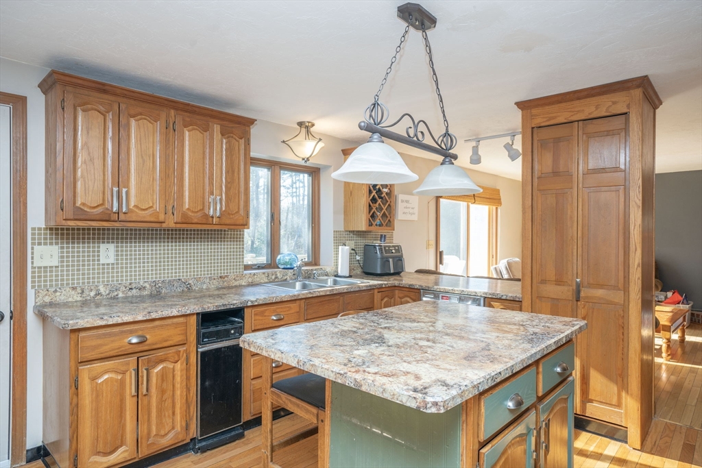 22 Dinahs Way Wareham, MA 02571 - Photo 13 of 42 a kitchen with center island table and chairs in it