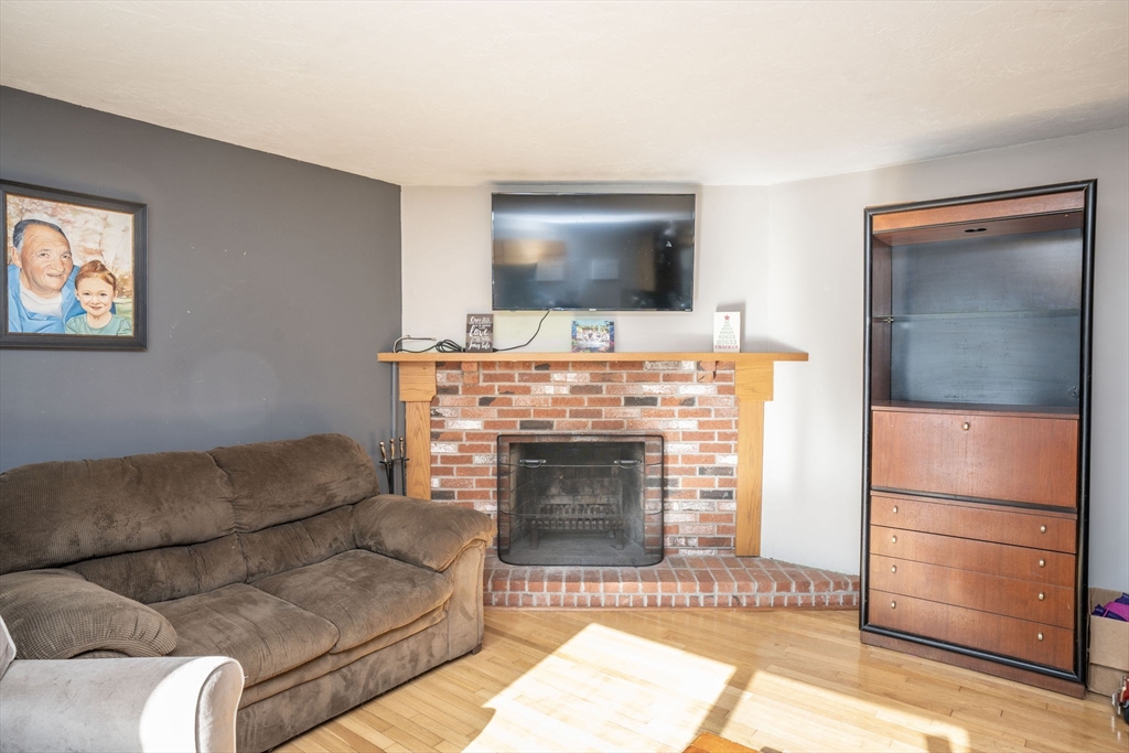22 Dinahs Way Wareham, MA 02571 - Photo 16 of 42 a living room with furniture a flat screen tv and a fireplace