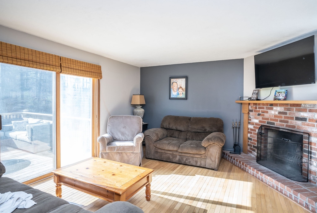 22 Dinahs Way Wareham, MA 02571 - Photo 17 of 42 a living room with furniture a flat screen tv and a fireplace