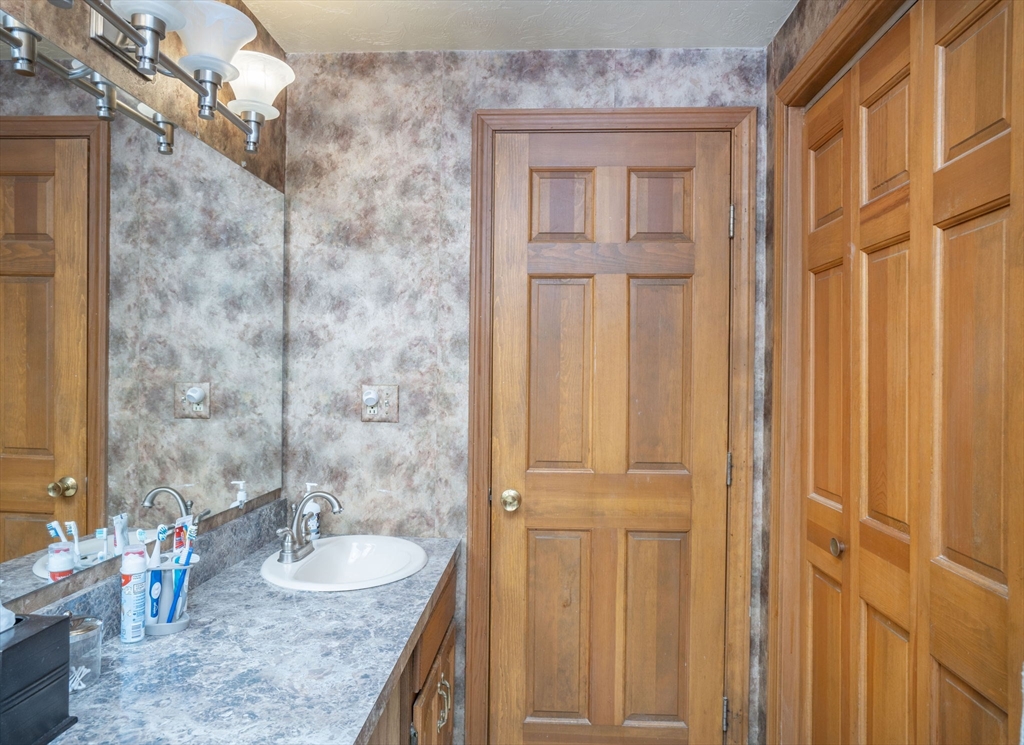 22 Dinahs Way Wareham, MA 02571 - Photo 28 of 42 a bathroom with a granite countertop sink and a mirror
