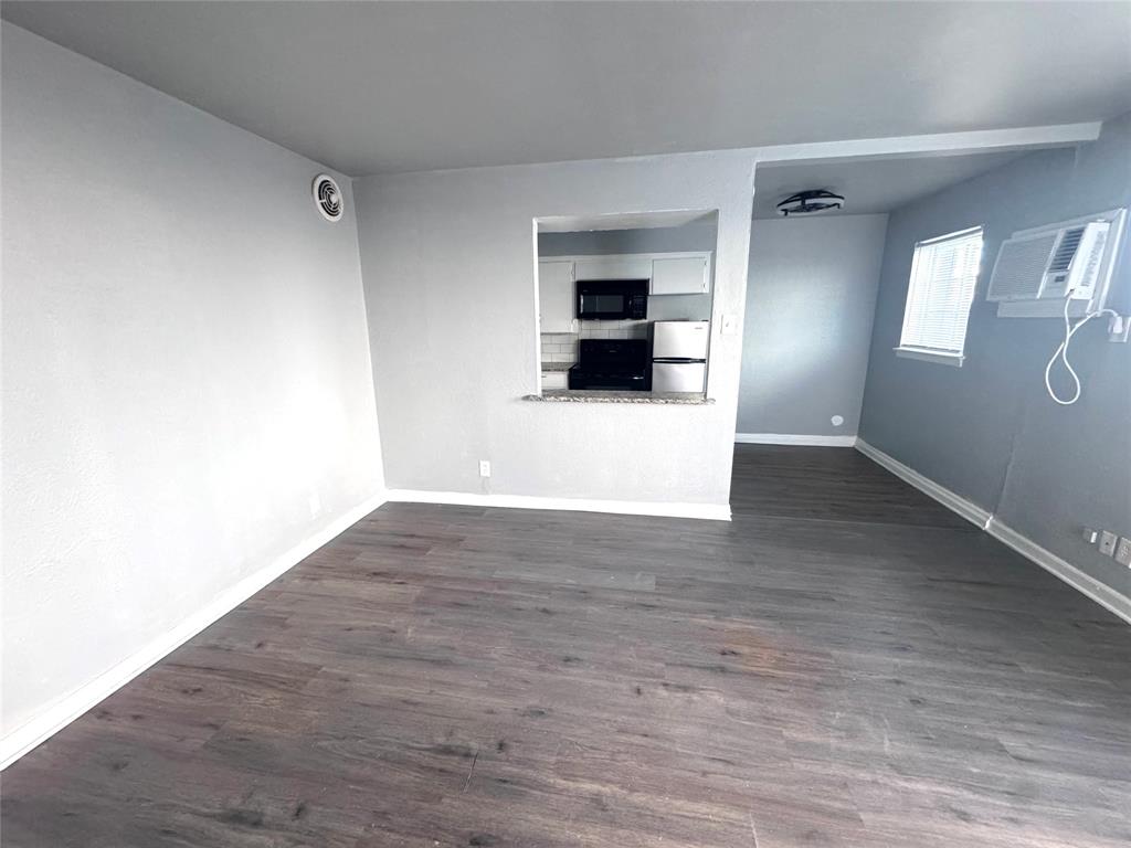 1417 Bennett Avenue Dallas, TX 75204 - Photo 6 of 14 a view of empty room with wooden floor and a window