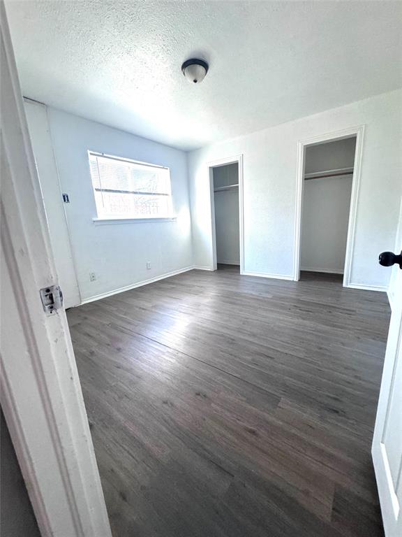 1417 Bennett Avenue Dallas, TX 75204 - Photo 8 of 14 an empty room with wooden floor and windows