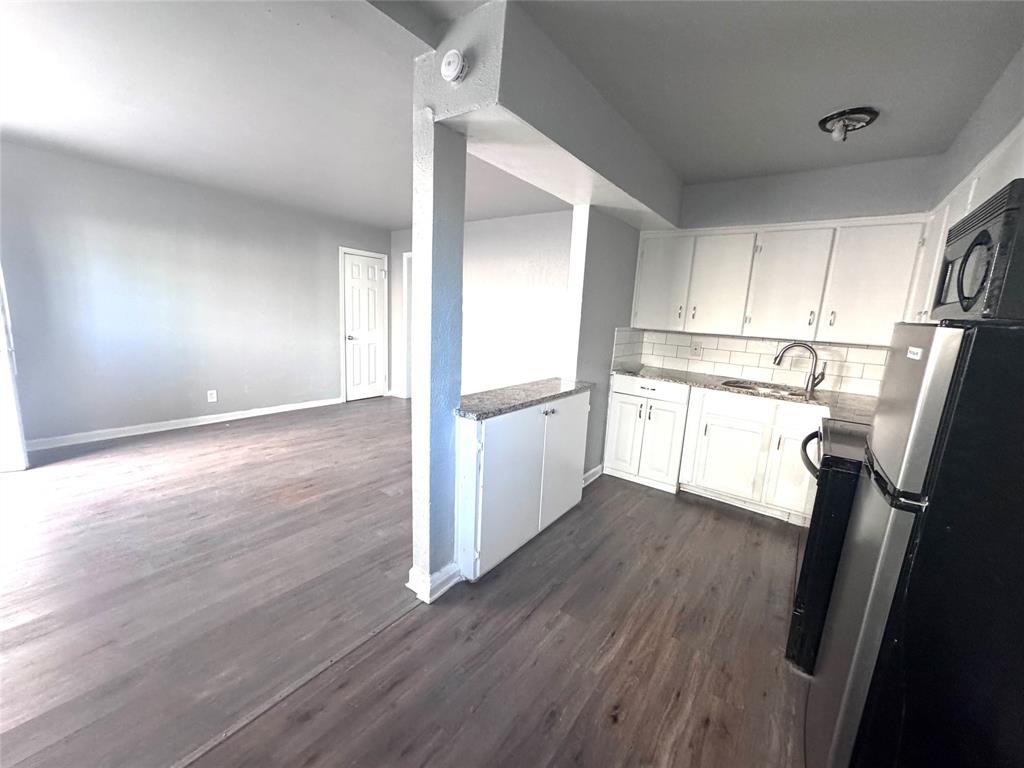 1417 Bennett Avenue Dallas, TX 75204 - Photo 10 of 14 a view of a kitchen with wooden floor and electronic appliances