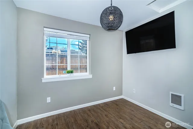 a view of a livingroom with a wooden floor and a flat screen tv