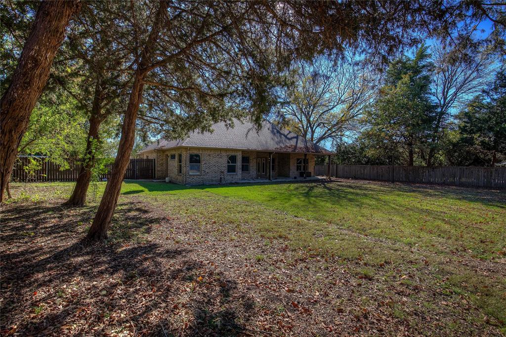 2617 Kirby Road Rowlett, TX 75088 - Photo 33 of 39 Back of property with a patio, brick siding, a fenced backyard, and a shingled roof
