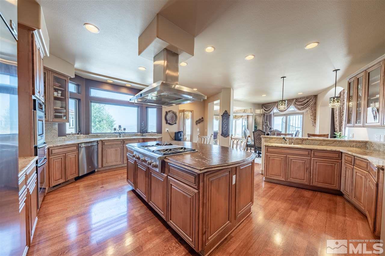 10055 Trailside Court Reno, NV 89511 - Photo 12 of 26 a kitchen with stainless steel appliances granite countertop wooden floors and sink