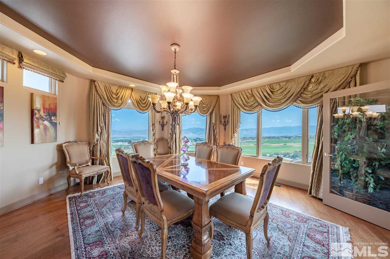 10055 Trailside Court Reno, NV 89511 - Photo 16 of 26 a view of a dining room with furniture a chandelier and wooden floor